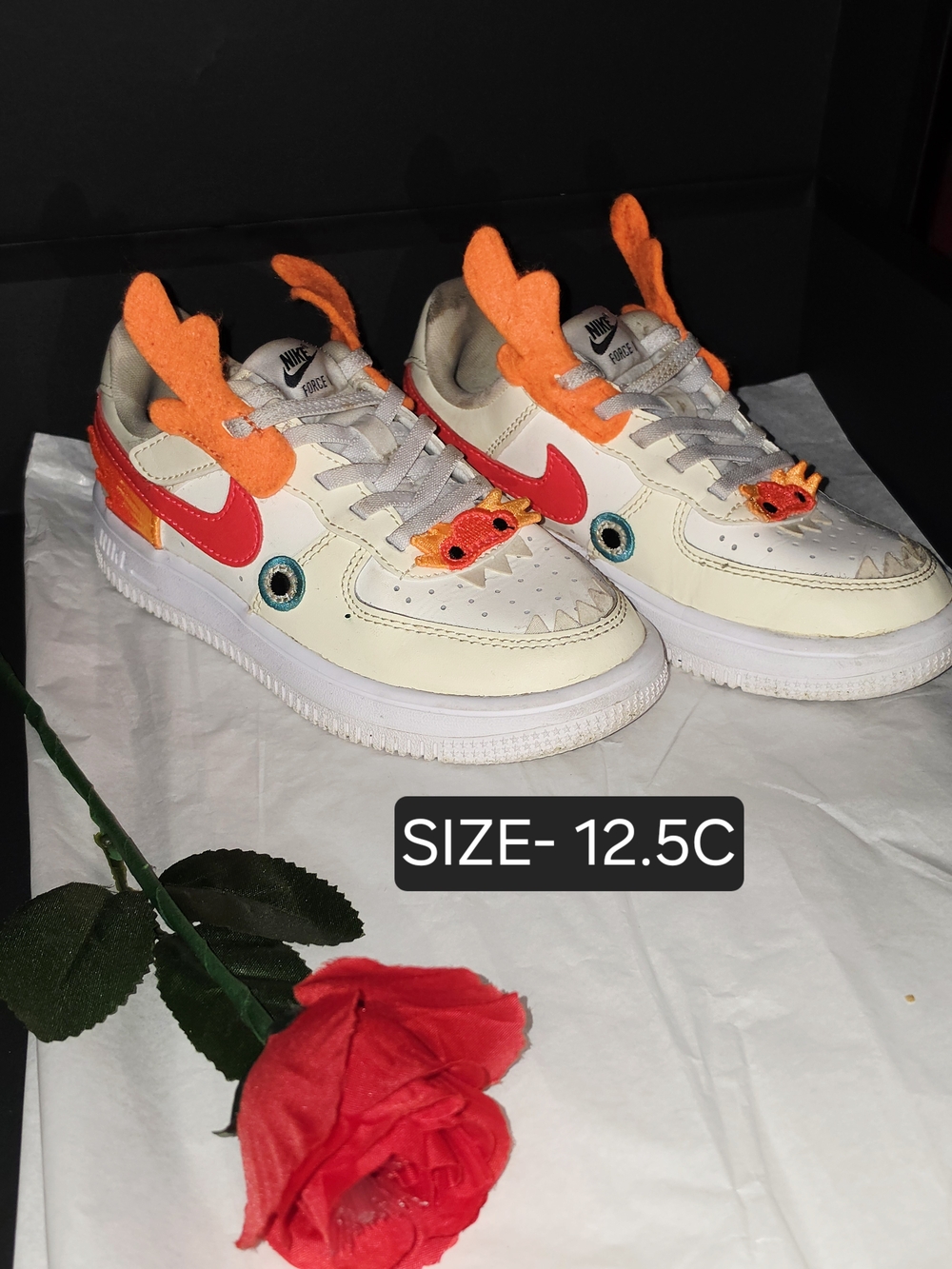 Kids Nike Cream Sneakers with Bright Orange Accents and Red Swoosh